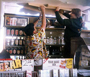 (Photo of Jason and Julie removing the donated beer sign from Pete's)